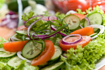 Fresh salad with onion, tomato and basil