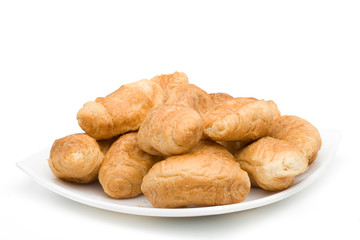 Fresh rolls on a plate on a white background