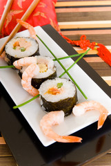 Plate with traditional Japanese sushi, sashimi rolls.