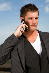 A caucasian businessman talking on the phone outdoor