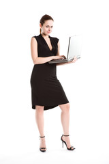 An isolated shot of a caucasian businesswoman carrying a laptop