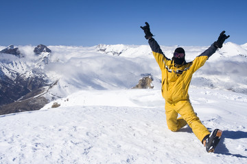 Skier takes a break on top of the mountain. French alps