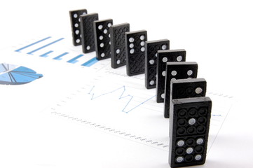 some domino stones on a blue  business chart