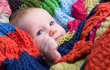 Portrait of three month old baby girl with big blue eyes
