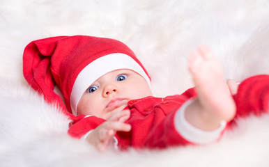 Portrait of Christmas baby girl in red Santa hat