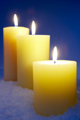 Group Of Lit Candles In Snow