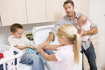 Father And Children Doing Laundry