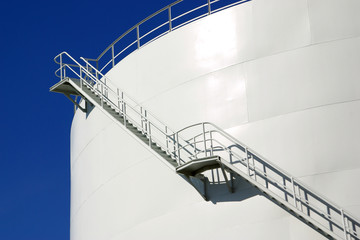 White industrial oil container with stairs in a refinery