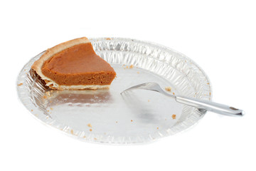 Fototapeta na wymiar one last piece of pumpkin pie on tin pie plate with fork