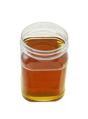 open jar of honey on white background