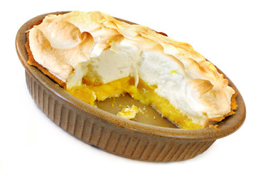 Home-baked lemon meringue pie, with a slice cut out.