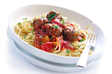 White bowl of spaghetti and meatballs in a bolognese sauce.