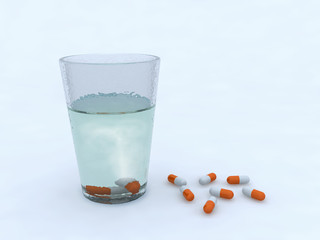 pills in a glass of water
