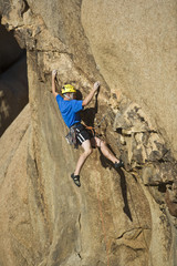 Climber scaling an overhanging rock face.