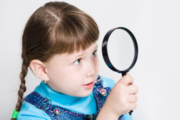Close-up of small girl holding looking glass in hand