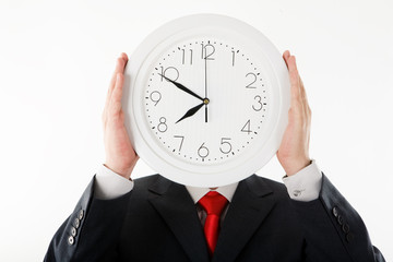 Image of clock in businessman&rsquo;s hands in front of his face