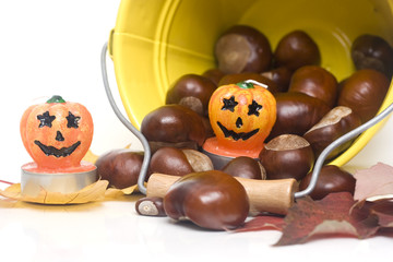 chestnuts spilling out from a yellow bucket