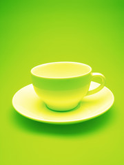 white cup and plate on  green background,  close up