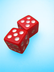 Two red dice on blue background, craps
