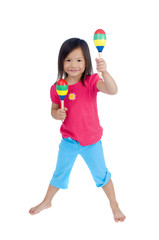 A young asian girl playing with maracas