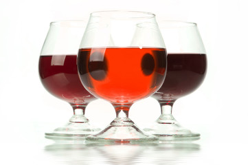 Dark wine in glasses on a glass table