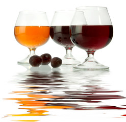 Dark wine in glasses on a glass table
