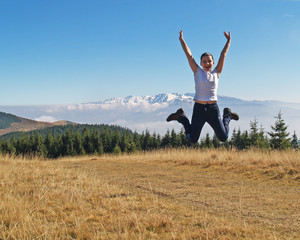 Fototapeta na wymiar beautiful woman jumping in the mountains