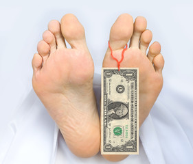 Two feet of  dead body, with banknote one dollar attached