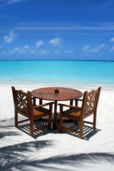 Fototapeta na wymiar Table and chairs on exotic beach