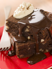 Stack Of Chocolate Brownies With Chocolate Fudge Sauce