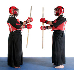 Two martial arts practicing ready to fight with wood swords