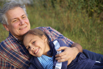 Cheerful father and daughter talking in park