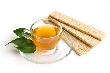 A mug of green tea and small loafs
