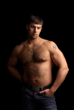 portrait of a strong muscular man, isolated on black