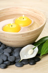 bowl of pure water and candles - beauty treatment