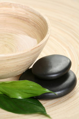 bowl of pure water and pebbles - beauty treatment