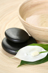 bowl of pure water and pebbles - beauty treatment
