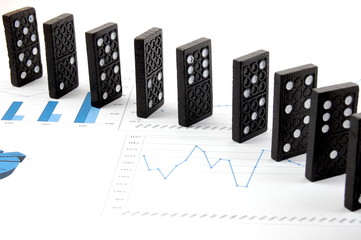 some domino stones on a blue  business chart