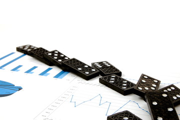some domino stones on a blue  business chart