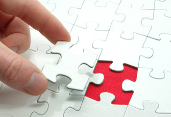 Fototapeta premium hands holding a puzzle piece