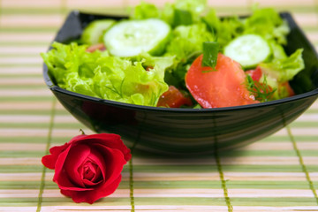 Fresh vegetables salad and red rose
