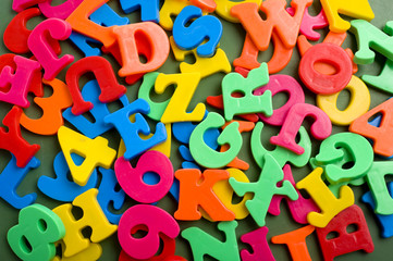 A grouping of plastic letter magnets forming a background