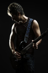Fototapeta premium young guitarist in the dark