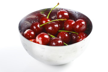 Red cherry in the metal bowl