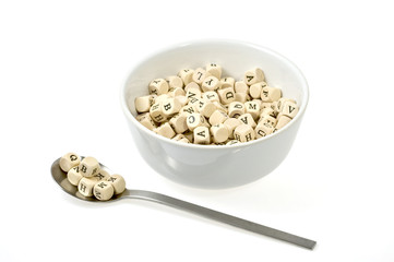 soop bowl and spoon with woodn dice depicting letters
