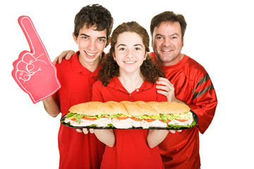 Sports fans getting ready to chow down on a giant sandwich.