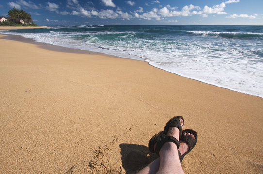 Man Relaxes on Tropical Shoreline on Kauai, Hawaii