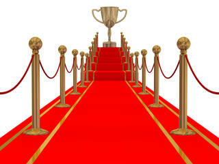 Gold cup of the winner on a red carpet path.