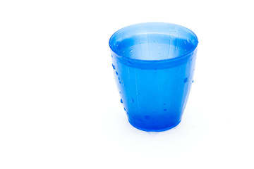 Blue plastic glass of pure spring water