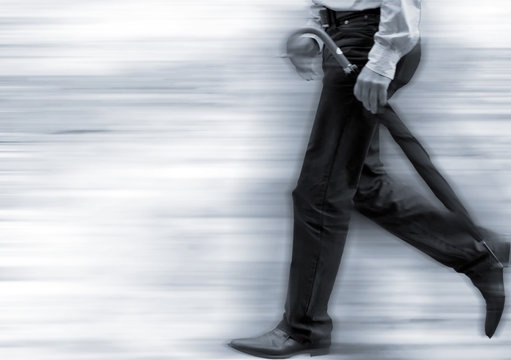 Illustrative Photograph Of Man Carrying Unbrella In High Street